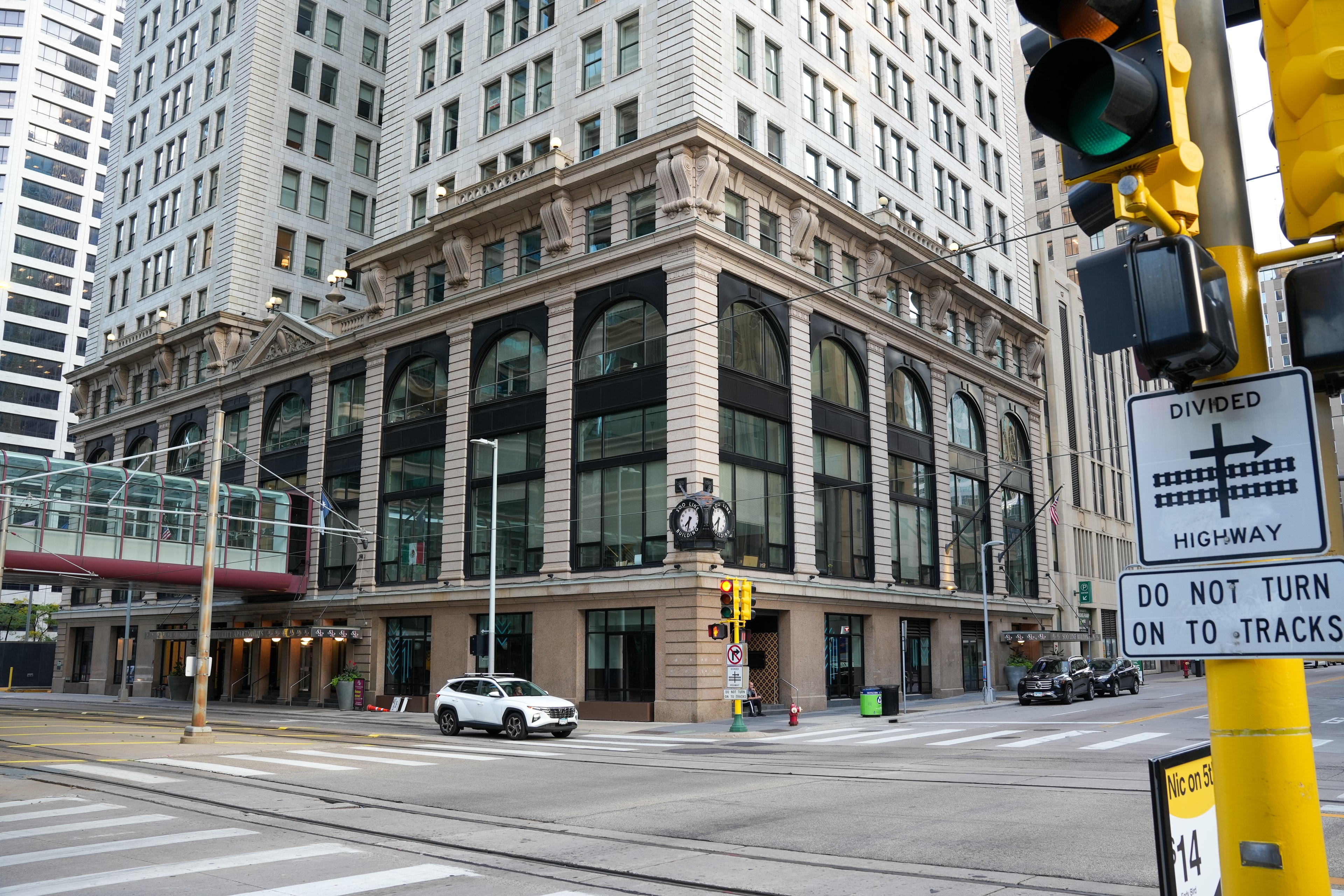 An ornate early-twentieth-century commercial building on a downtown corner, its arched windows facing an empty intersection.